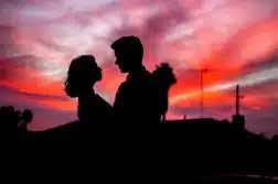 silhouette of man and woman facing each other during golden hour