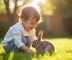 Jeune enfant riant en câlinant un petit lapin dans un jardin ensoleille
