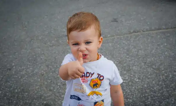 a baby with his finger in his mouth