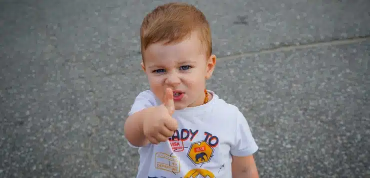 a baby with his finger in his mouth